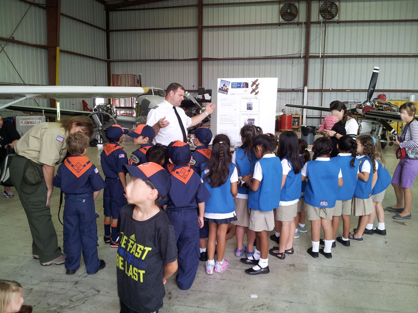 Image of Boy and Girl Scouts talking with a pilot
