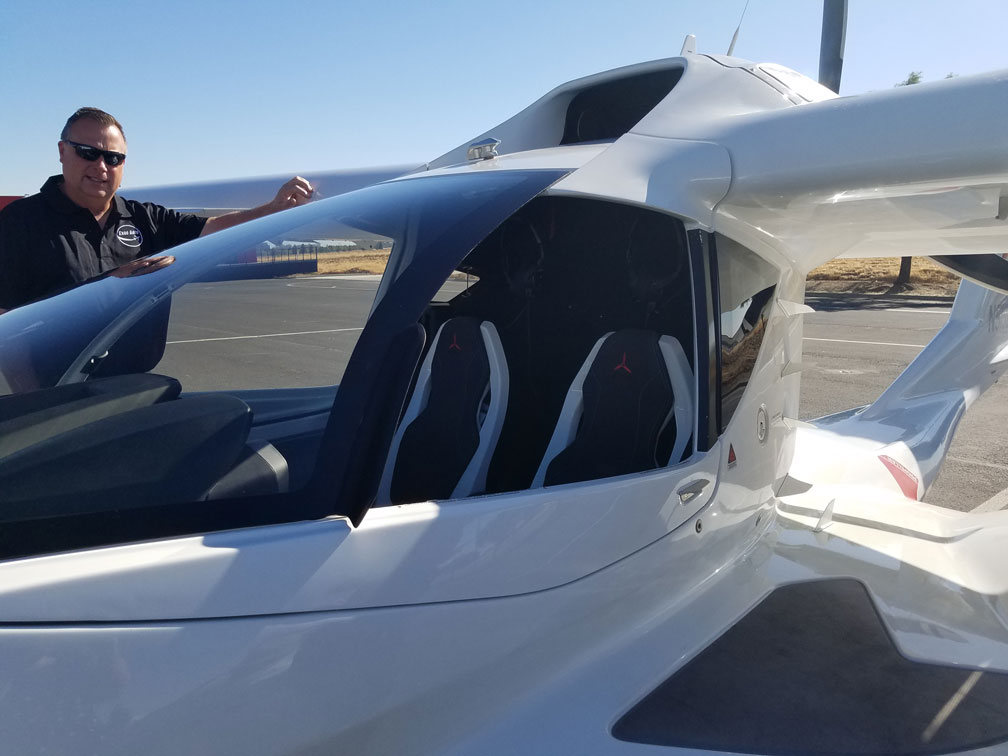 a man standing next to an ICON Aircraft plane