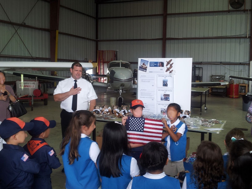 Image of Boy Scouts and Girl Scouts pledging allegiance to the flag