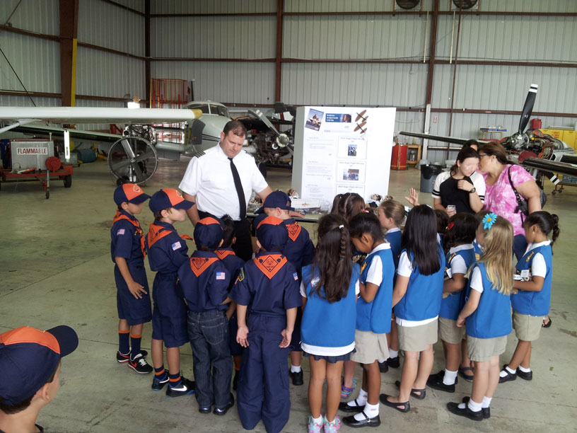 Image of Boy and Girl Scouts talking with a pilot