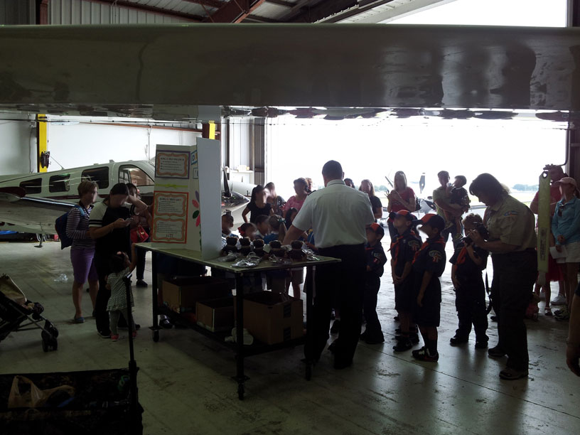 Image of Boy and Girl Scouts talking with a pilot