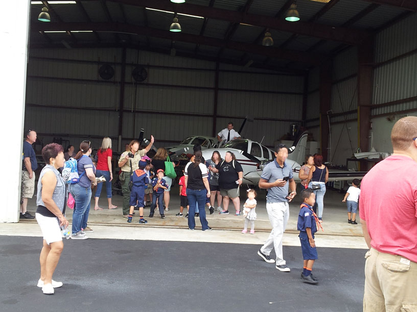 Image of group looking at airplane